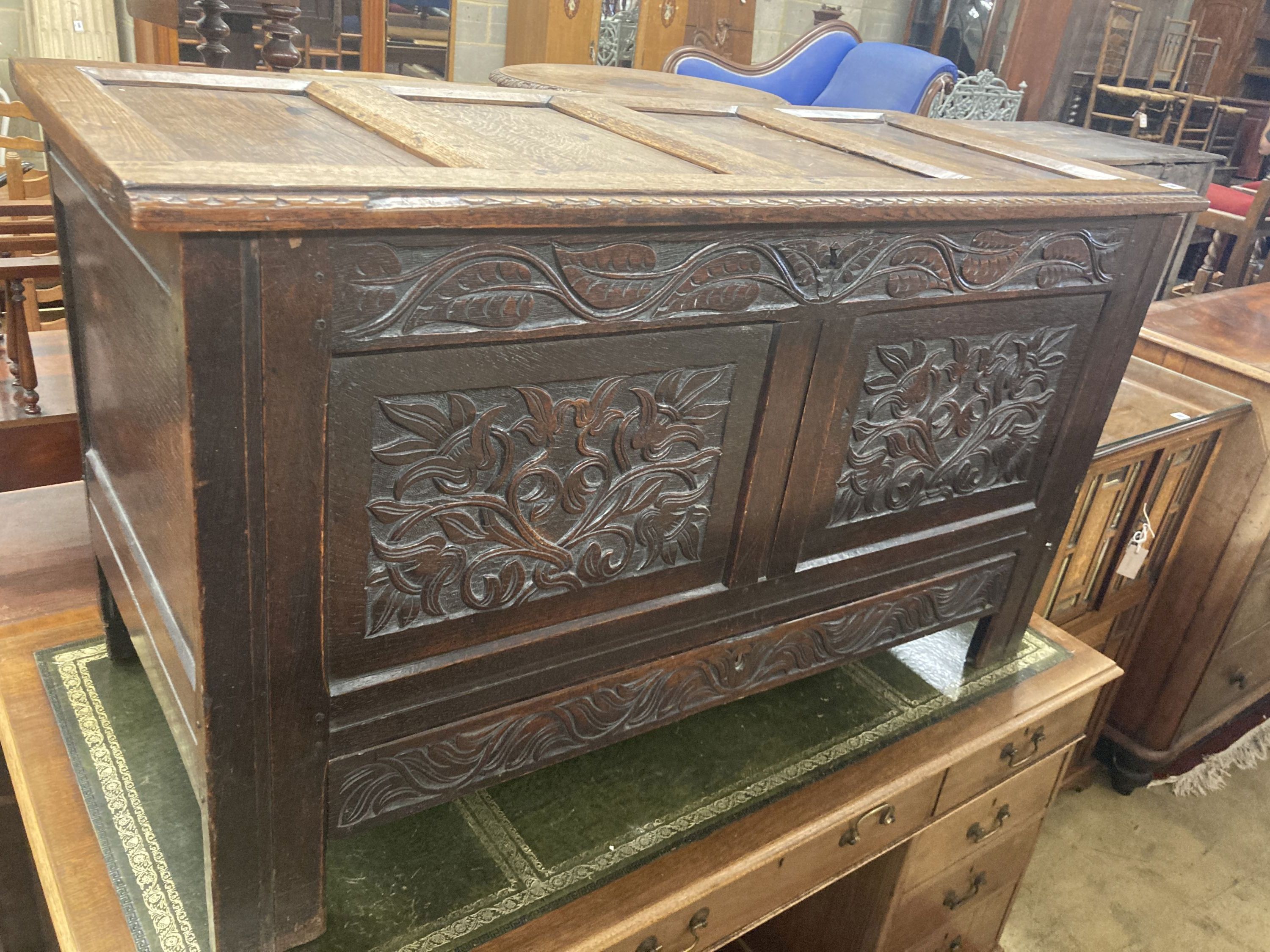 An 18th century carved panelled oak coffer, fitted drawer, length 130cm, depth 58cm, height 75cm